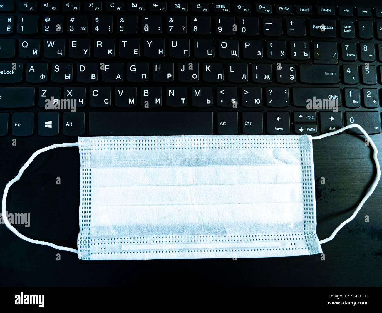 Computer Medical Mask Medical face mask on black computer keyboard Stock Photo - Alamy