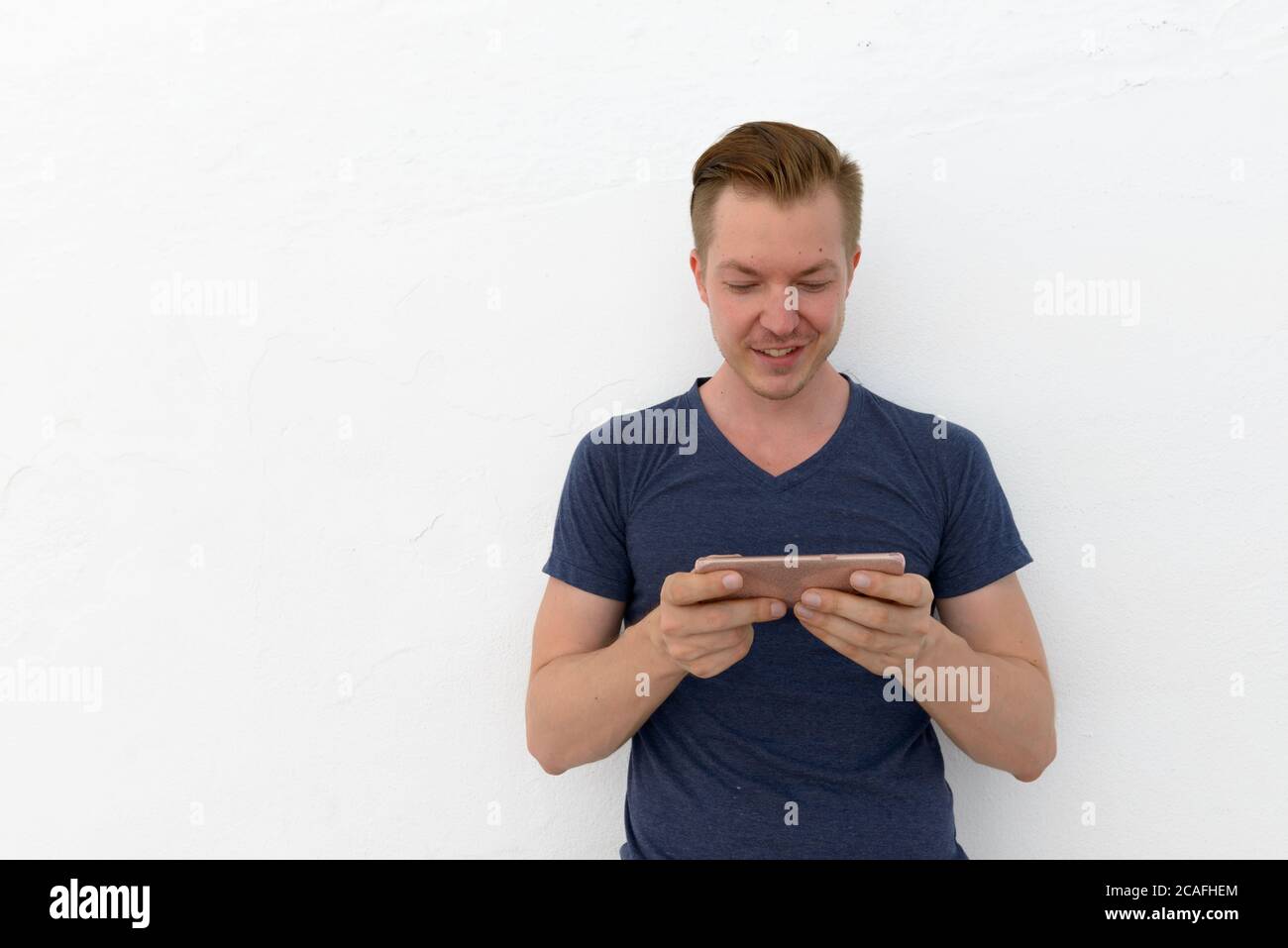 Portrait of young handsome man against white background Stock Photo - Alamy