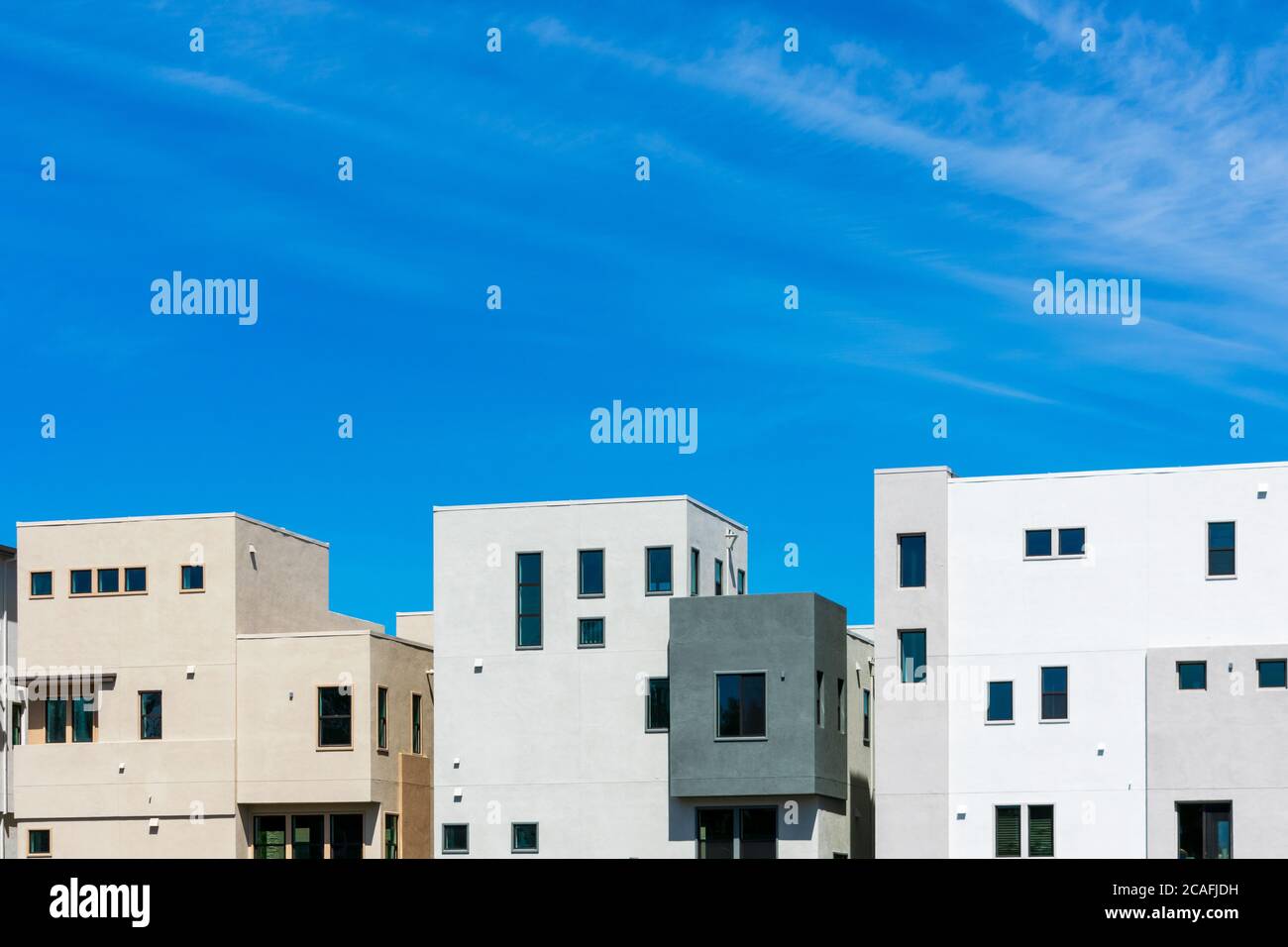 Exterior view of typical new multifamily low-rise residential row building under beautiful blue sky Stock Photo