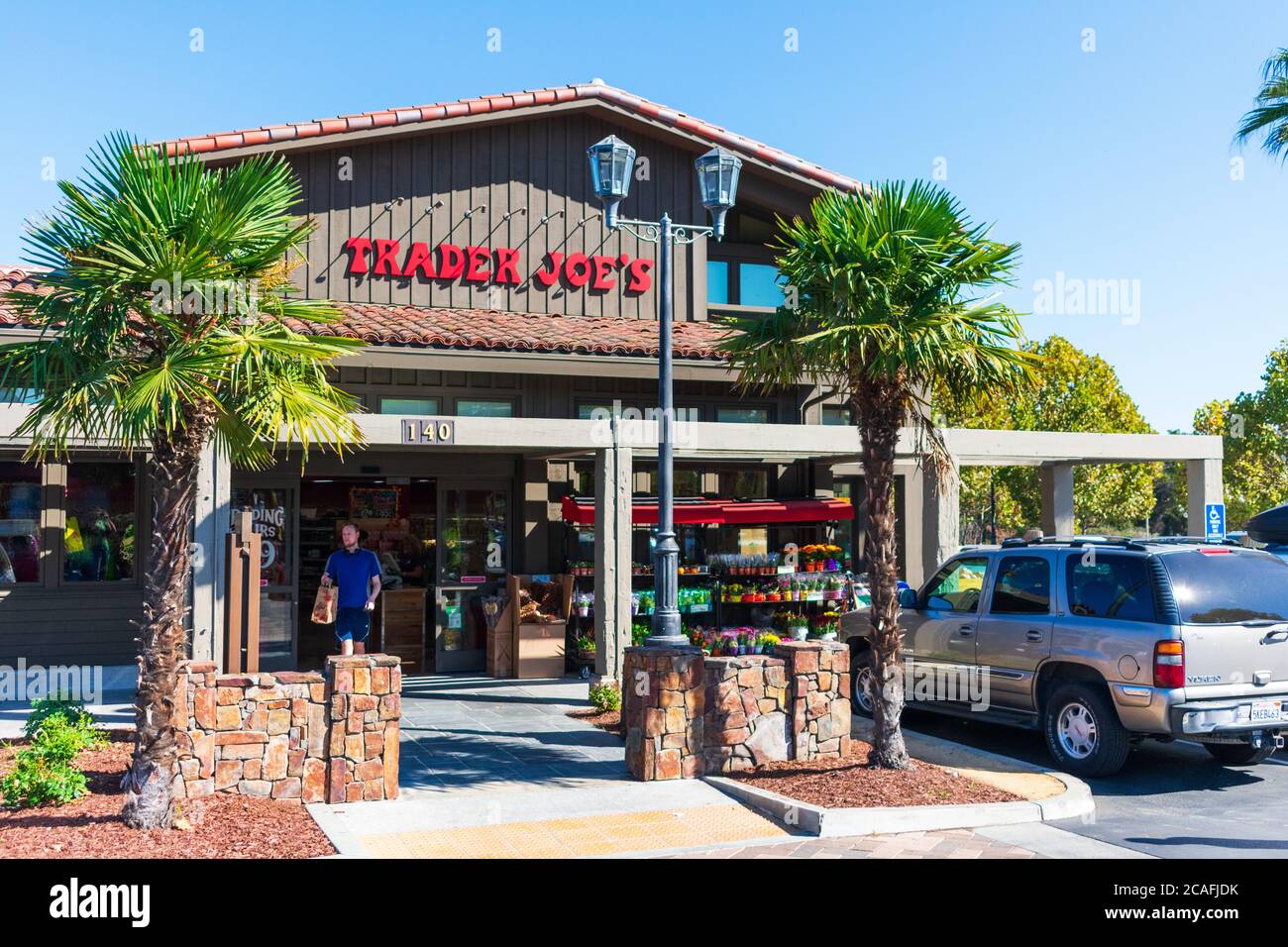 Trader Joe's storefront with palm trees landscape at entrance- Palo Alto, California, USA - 2018 Stock Photo