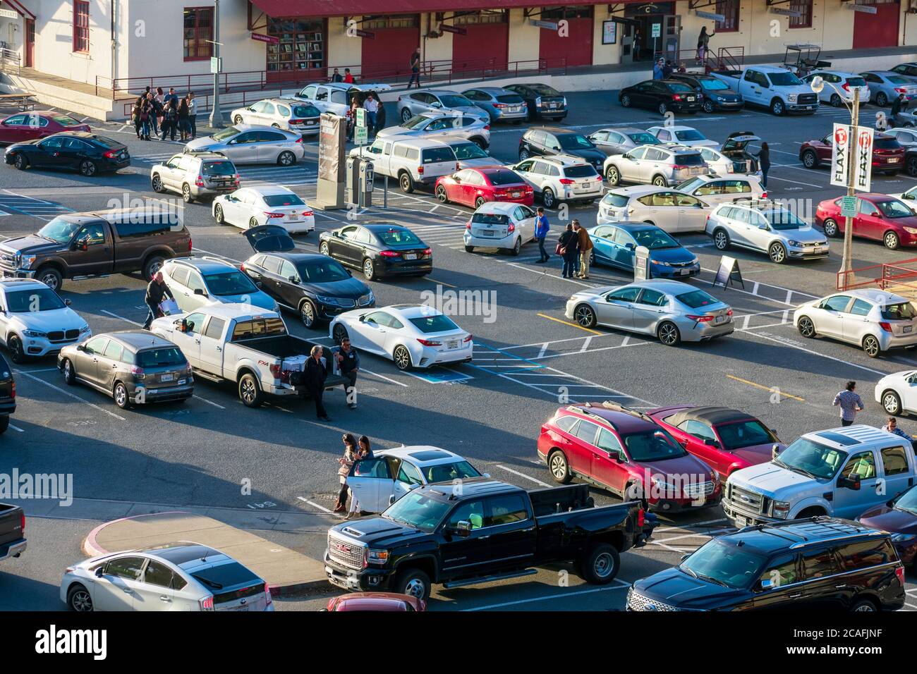 Aerial view of busy and full parking lot with cars arriving and leaving, people waiting at Fort Mason Center for Arts and Culture Stock Photo