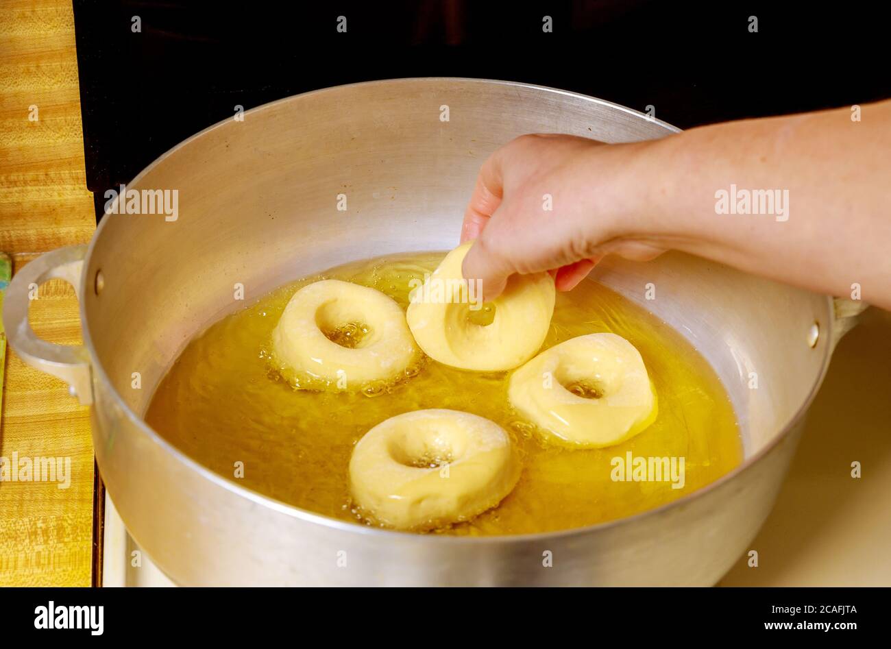 Woman frying sweet donuts in hot oil Stock Photo Alamy