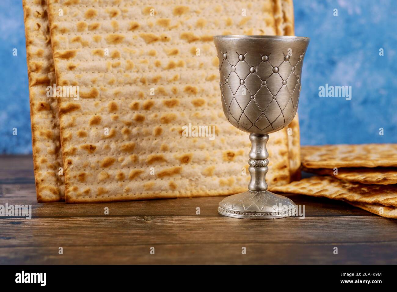 Jewish matzah bread with cup of wine on wooden rustic background ...