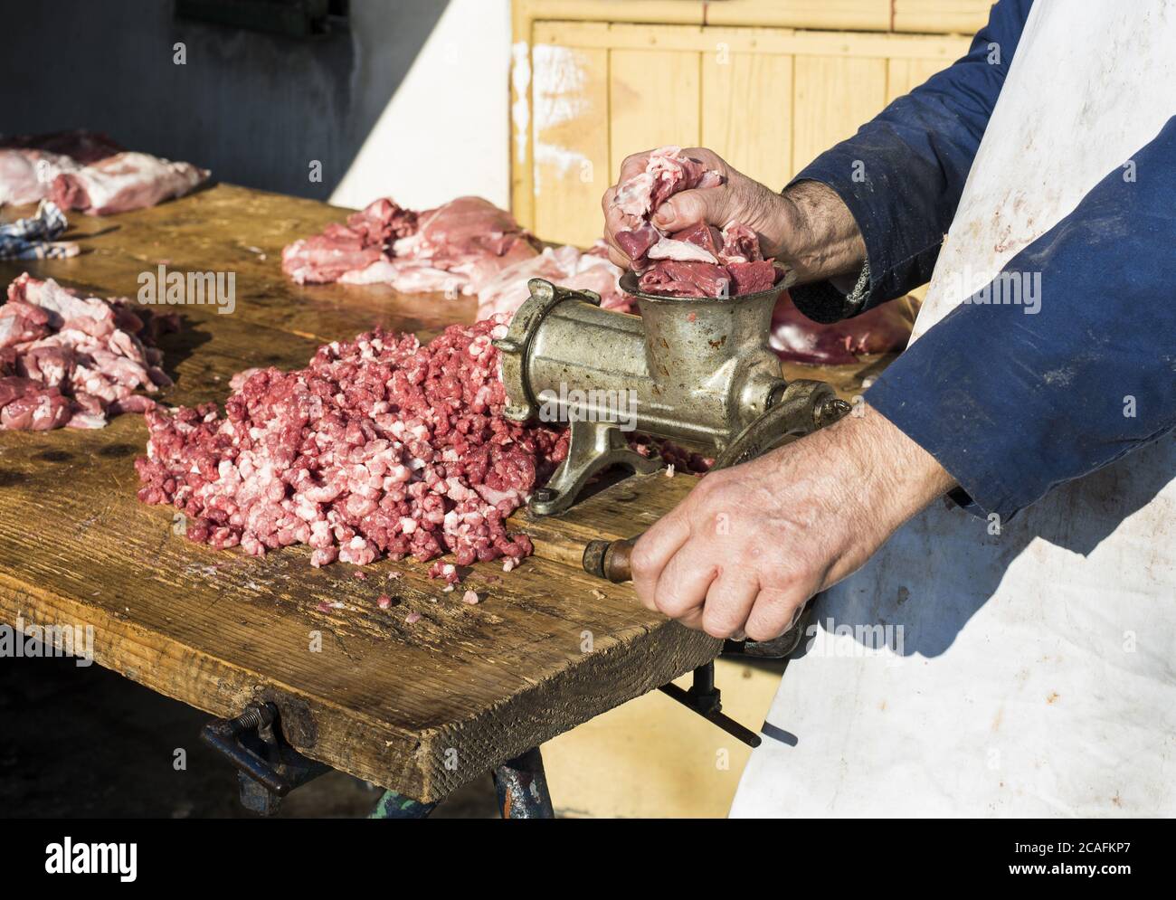 Close up shot of person grinding meat on a meat grinder Stock Photo - Alamy