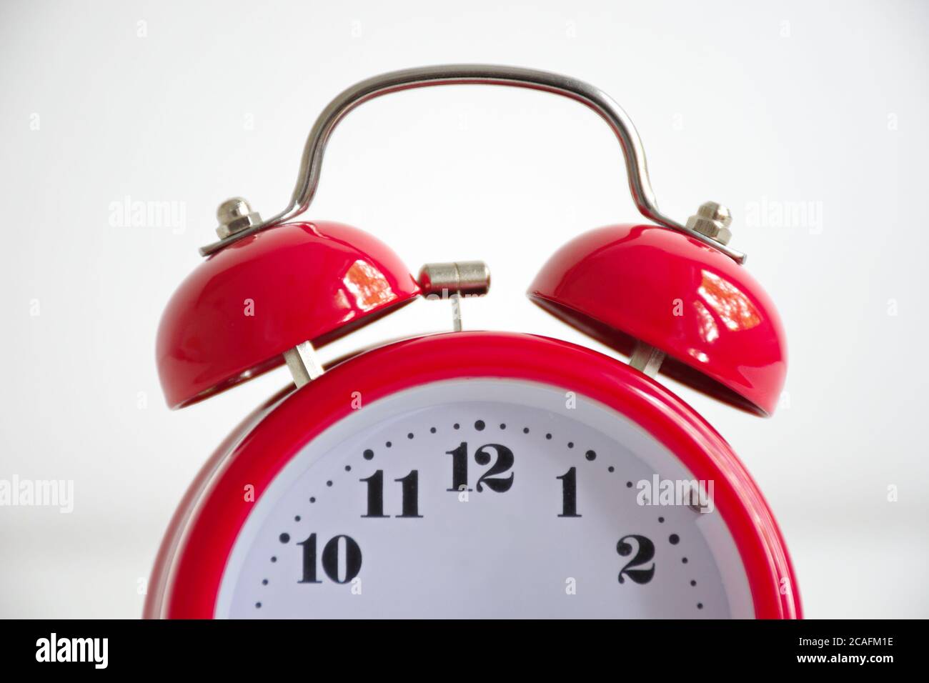 Red vintage alarm clock against the white background Stock Photo Alamy