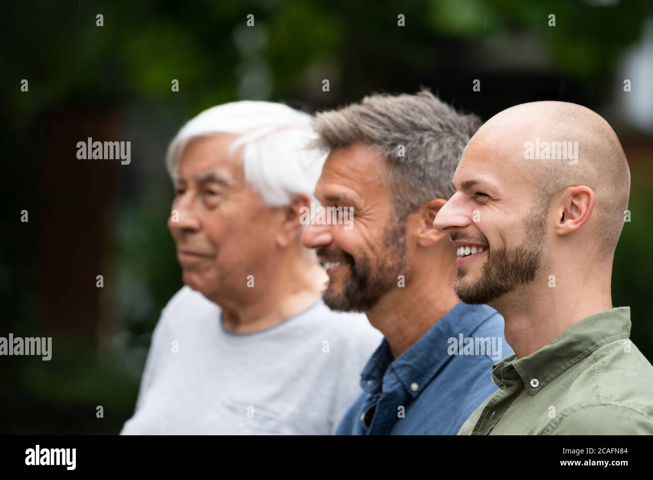 Three Generation Men Family Portraits Side View Stock Photo