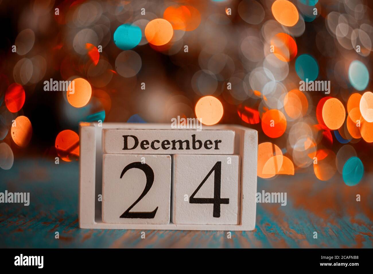 December 24 Th On Wooden Calendar Cube With Christmas Tree Lights december-24-th-on-wooden-calendar-cube-with-christmas-tree-lights