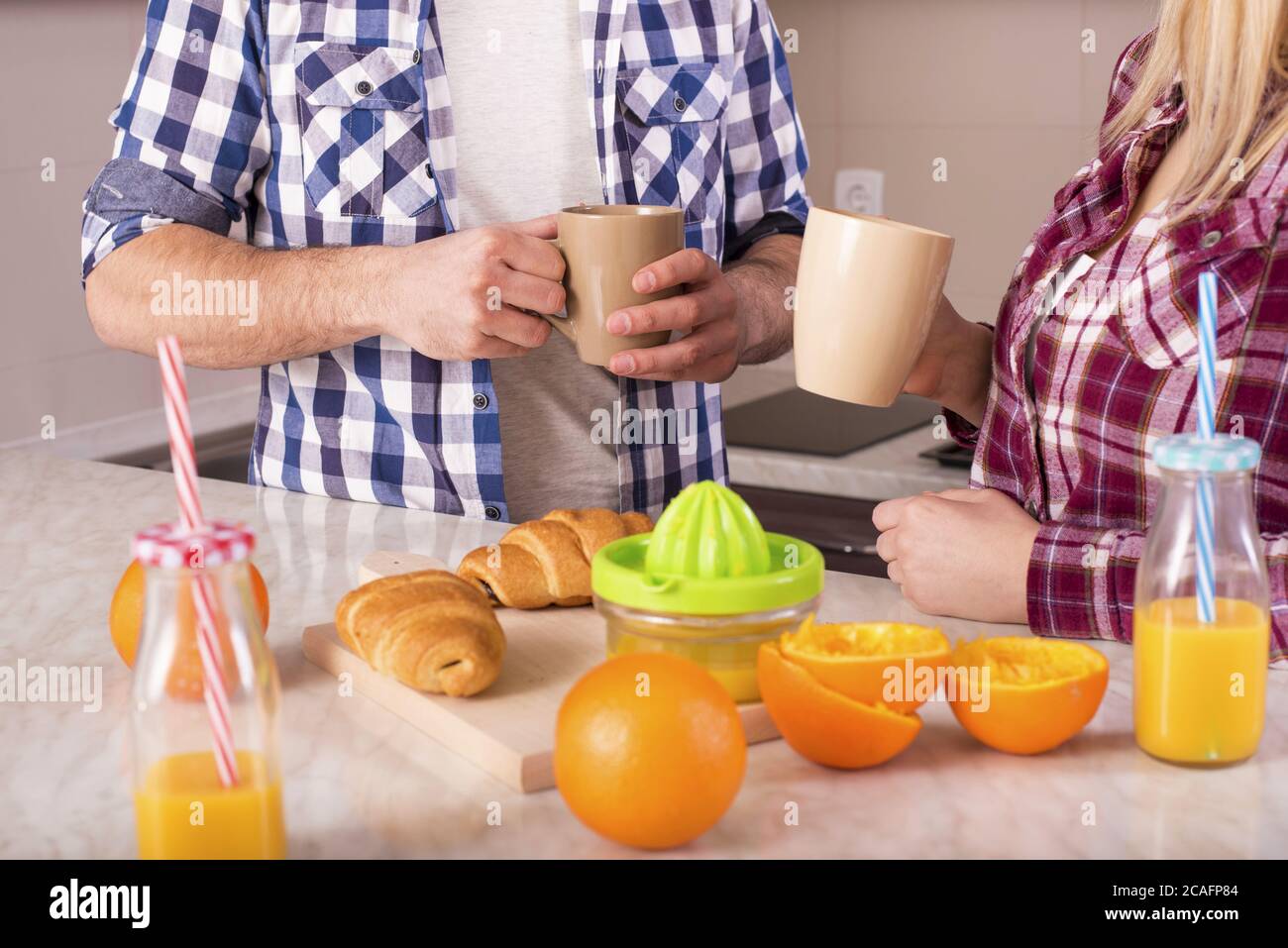 Lovely couple having breakfast in the kitchen Stock Photo
