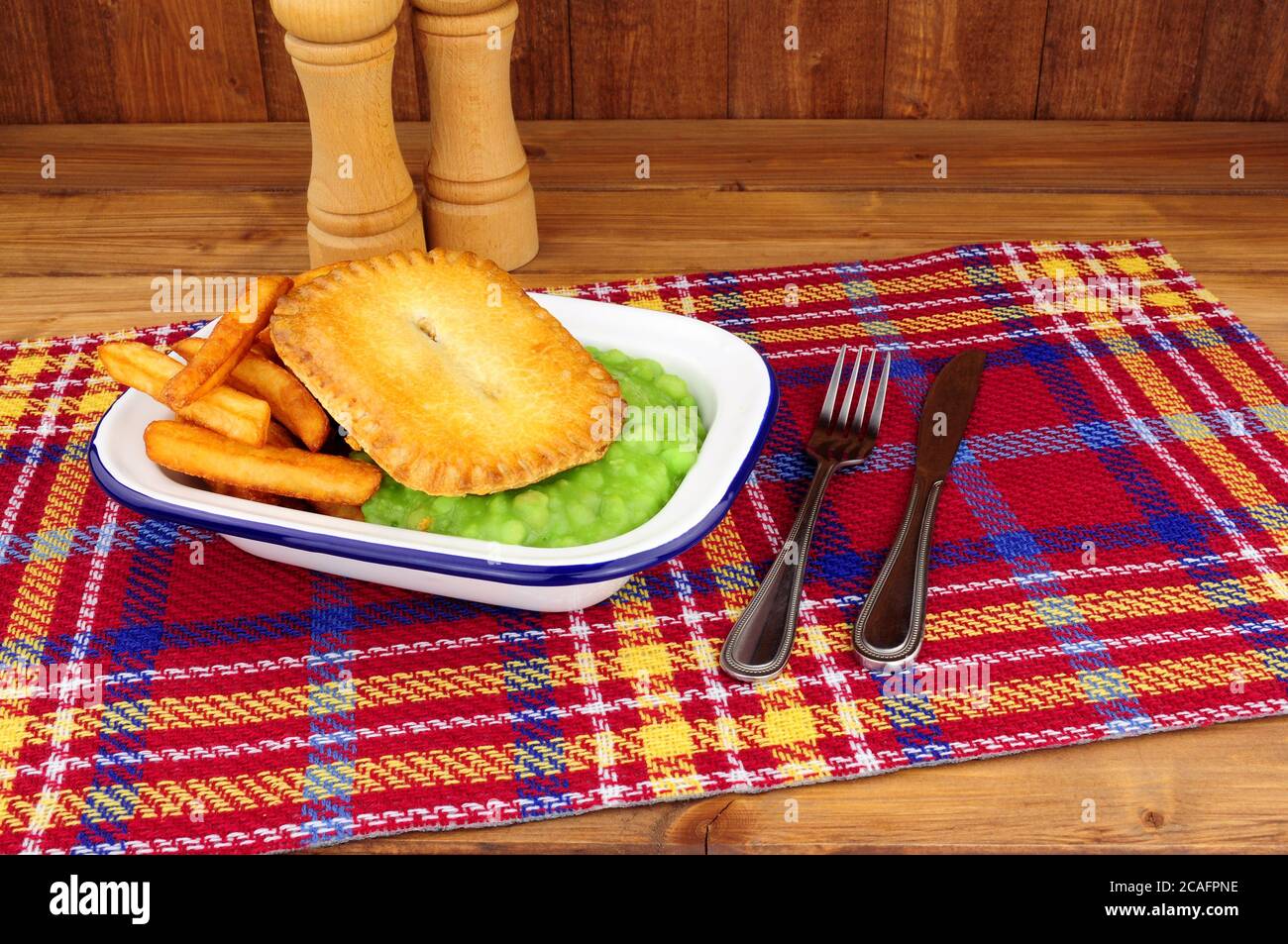 Steak and kidney pie and chips meal with mushy peas in a metal enamel dish Stock Photo Alamy