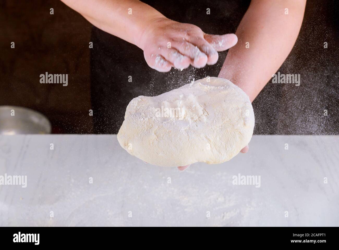Person kneading pizza dough in hands for pizza making Stock Photo - Alamy