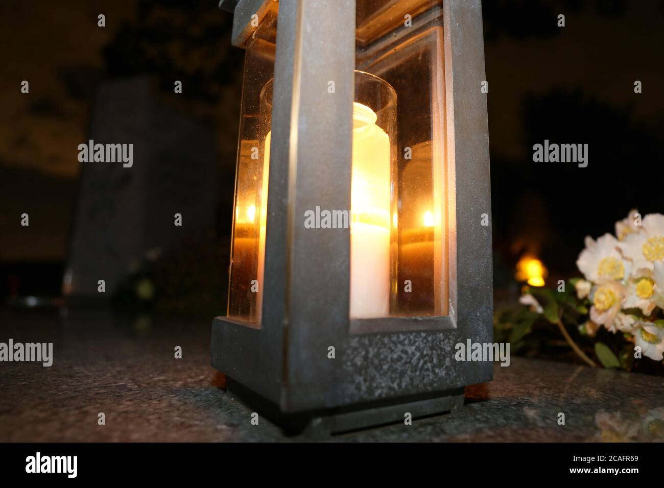 Lighting candles for the dead on All Saints Day Stock Photo Alamy