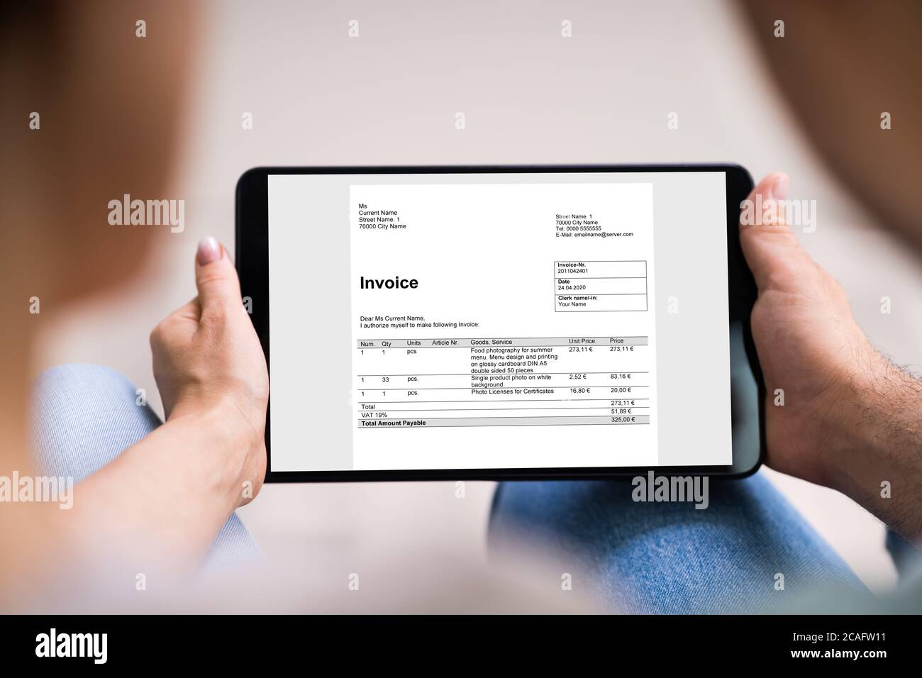Young Couple Looking At E Invoice On Tablet Stock Photo