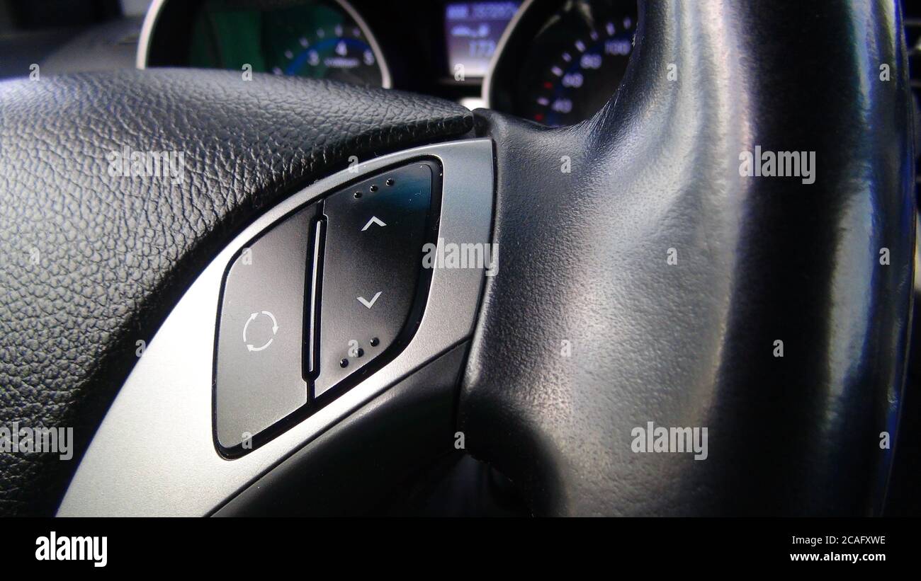 Modern black steering wheel with multifunction buttons for quick