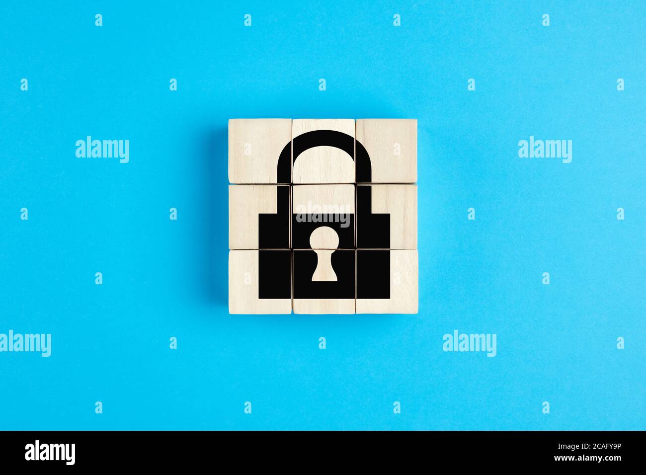 Lock icon on wooden cubes on blue background. Isolation, quarantine or data security concept. Stock Photo