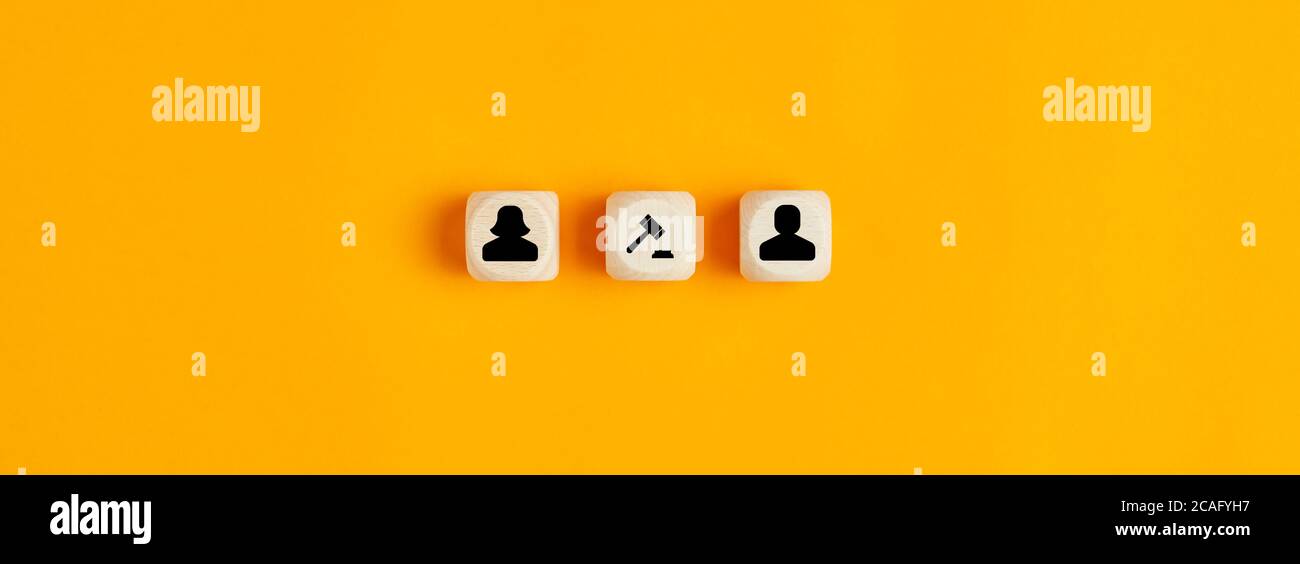 Male, female and judge's gavel icons on wooden blocks on yellow background. Concept of divorce or breakup. Stock Photo