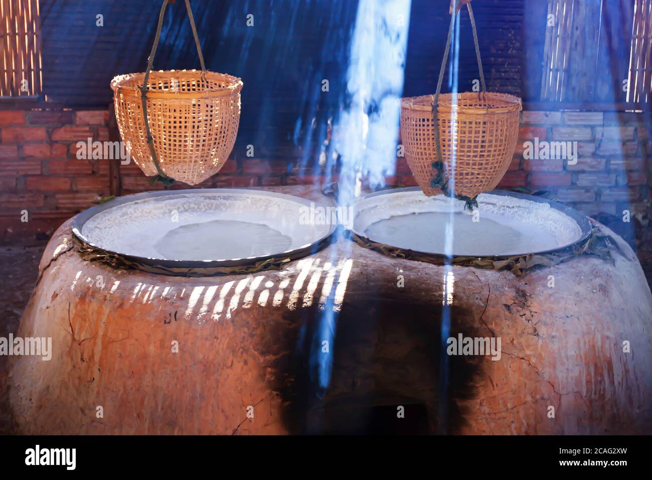 Boiling rock salt on clay oven, traditional boiling rock salt on firewood oven, rural scene in Bo Kluea, Nan, Thailand. Focus on clay oven. Stock Photo