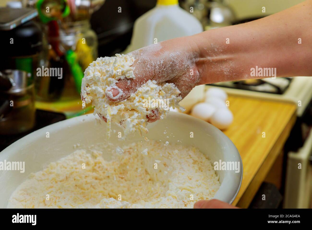 Woman making dough for baking cheese bread called chipa. Cuisine of Paraguay. Stock Photo