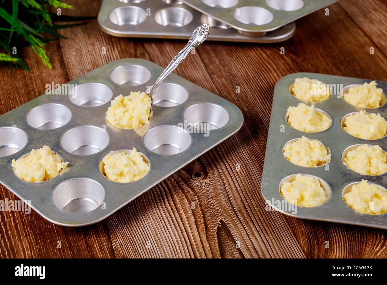 Cooking brazilian cheese bread chipa in baking pan with spoon. Stock Photo