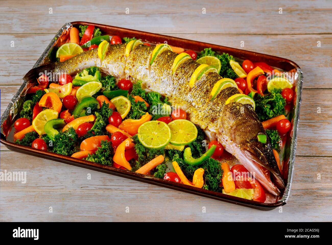 Fresh pike with colorful vegetables and spices on baking tray Stock ...