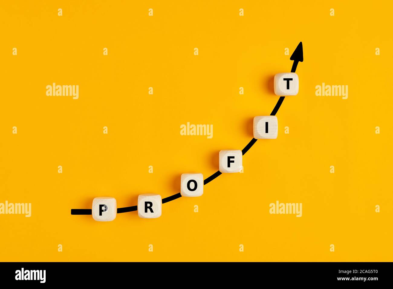 Financial or business profit growth concept with text letters on wooden blocks with an ascending arrow graph Stock Photo
