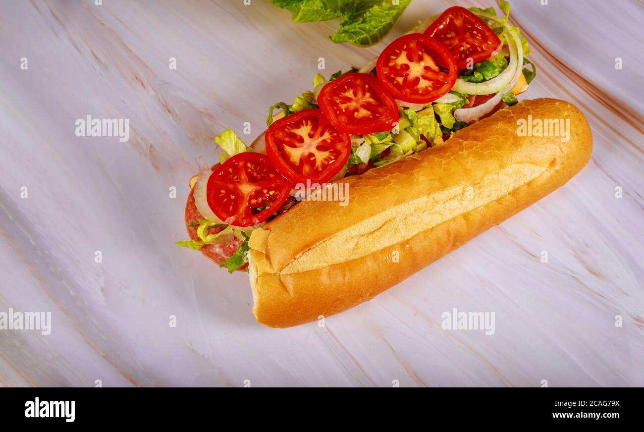 Sandwich with french long bread, muenster cheese, salami and vegetable