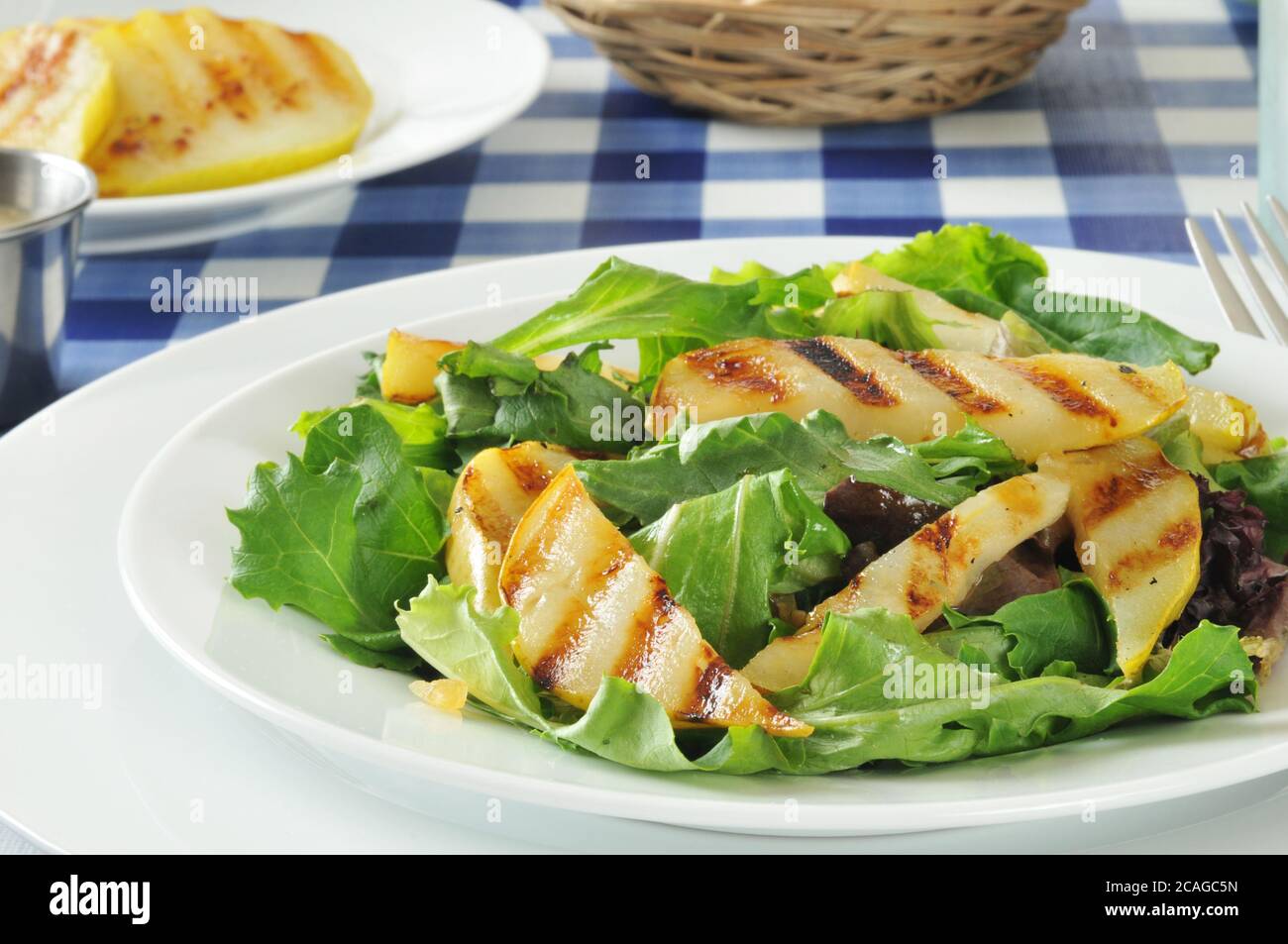 Grilled pear salad on romaine, green leaf and tango lettuce Stock Photo ...