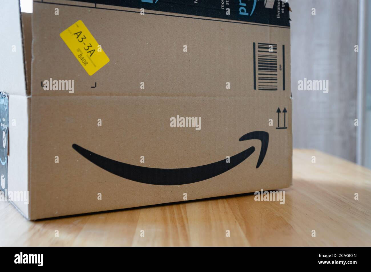 Amazon standard shipping box in EU with Amazon Prime logo scotch tape. Amazon.com, Inc., is an American multinational tech company Stock Photo