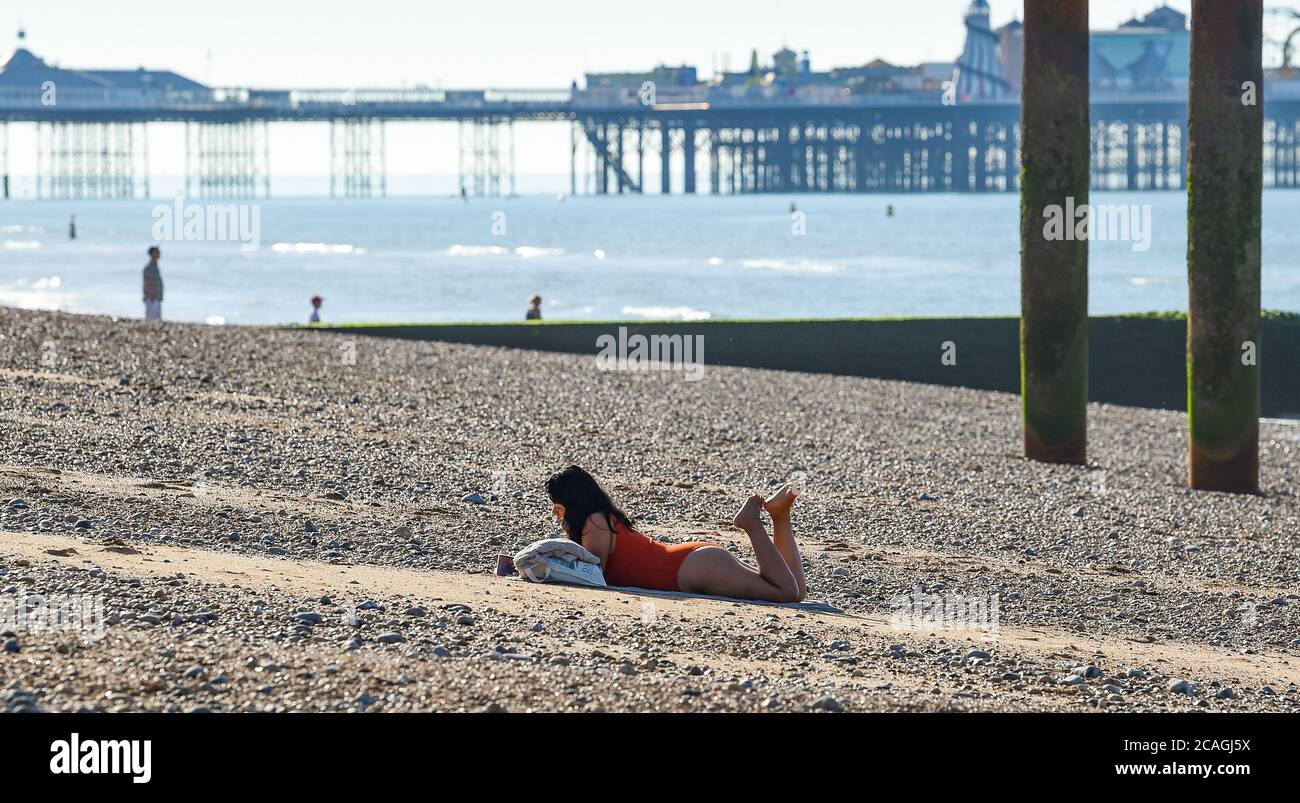 Brighton UK 7th August 2020 An early morning sunbather enjoys another