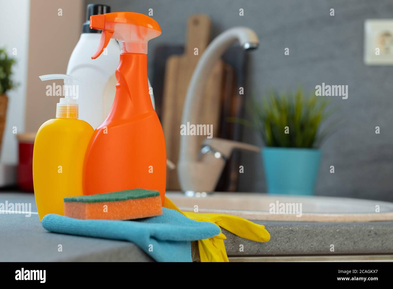 Household chemicals product bottles standing near the kitchen sink