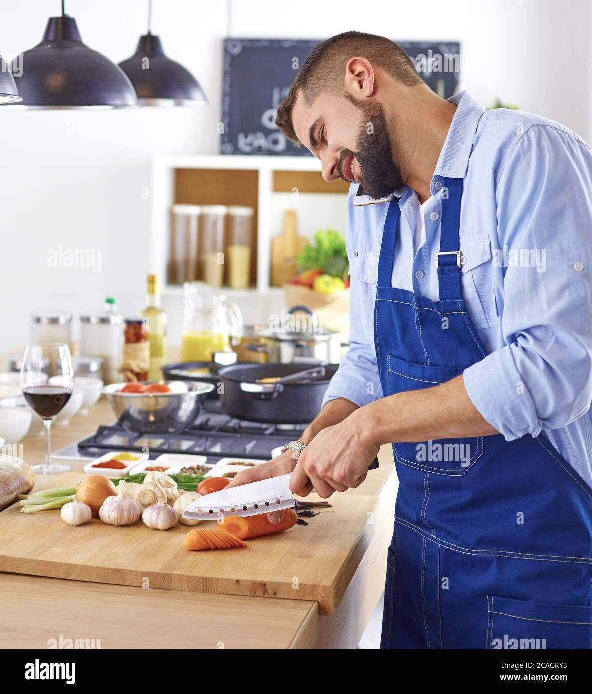 Young chef prepares a man in the kitchen Stock Photo
