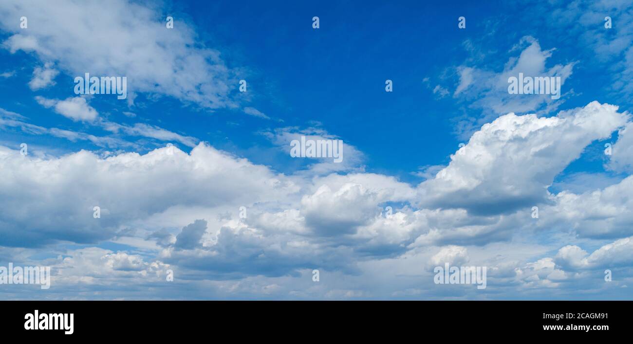 Contrasting expressive clouds against the blue sky. Stock Photo