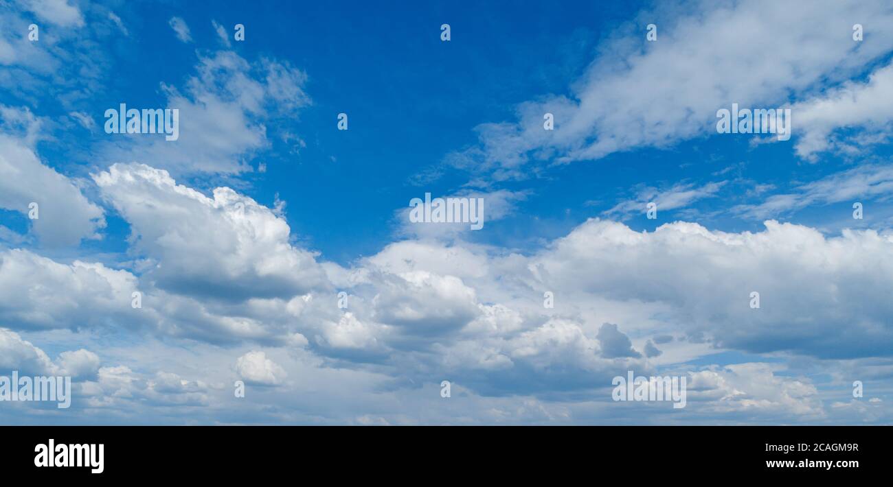 Contrasting expressive clouds against the blue sky. Stock Photo