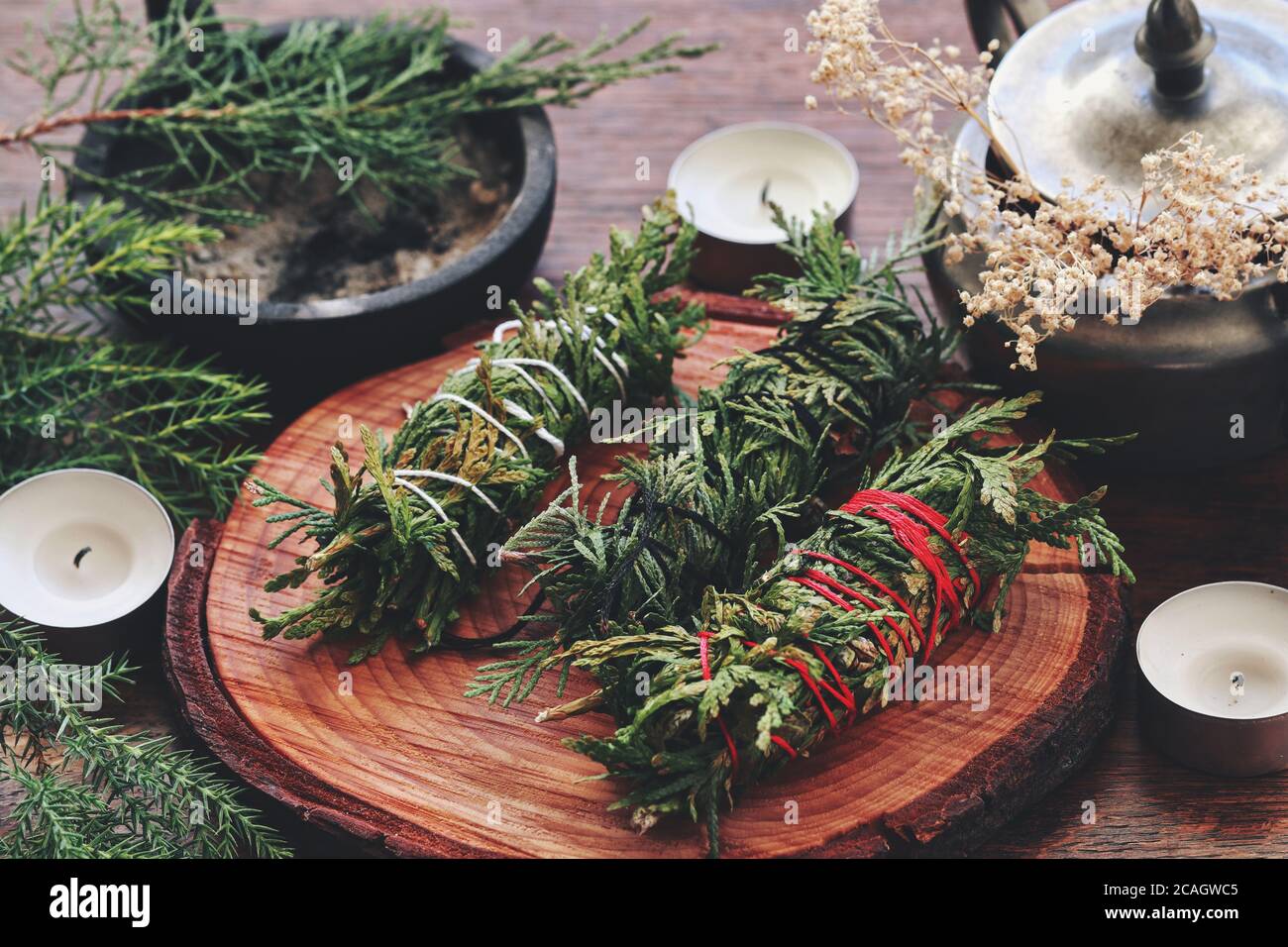 Evergreen cleansing sticks for Yule winter solstice Christmas celebration. Different types of smoke cleanings bundles made from cedar Stock Photo