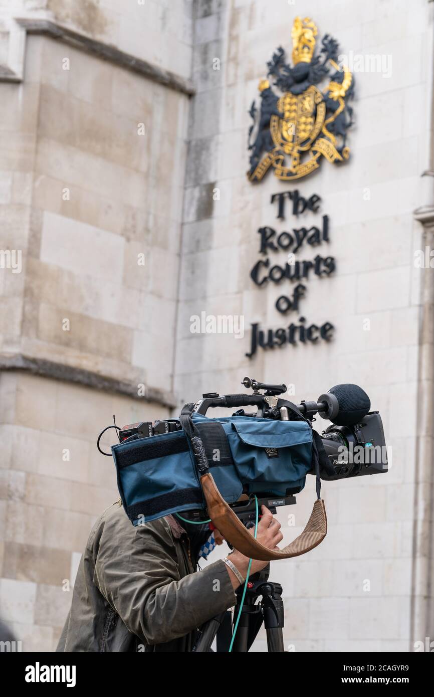 LONDON, ENGLAND - JULY 28, 2020: Lone Press Videographer cameraman outside the the Royal Courts of Justice, The Strand, London - 409 Stock Photo