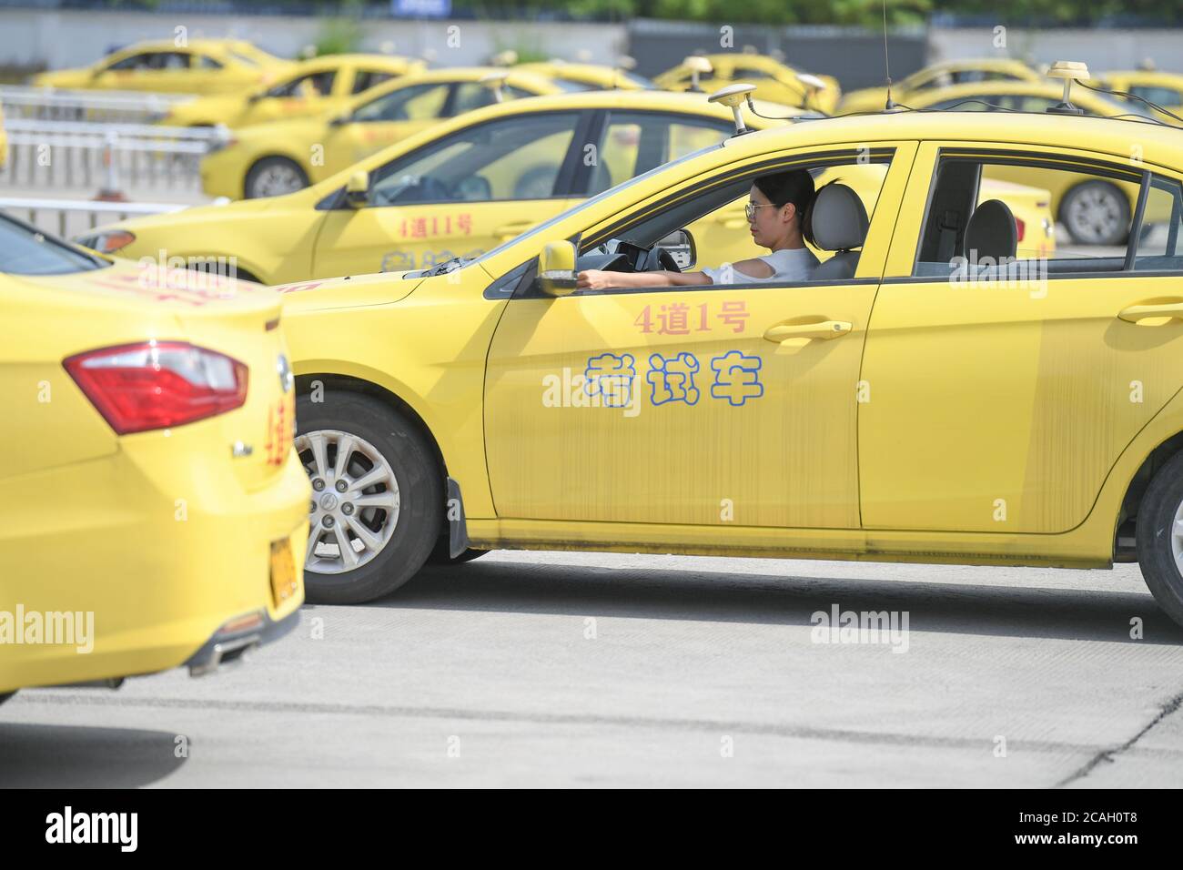 Fuzhou, China. 07th Aug, 2020. A driving test candidate waits in a car at a driving test venue in Fuzhou, capital of southeast China's Fujian Province, Aug. 7, 2020. According to the data provided by Fuzhou traffic police, since the resumption of the full subject test for small vehicle drivers on April 15, the daily booking volume of major driving test venues in Fuzhou has continued to rise. Especially during the summer vacation, the number of student-based driving test candidates continues to increase. Credit: Xinhua/Alamy Live News Stock Photo