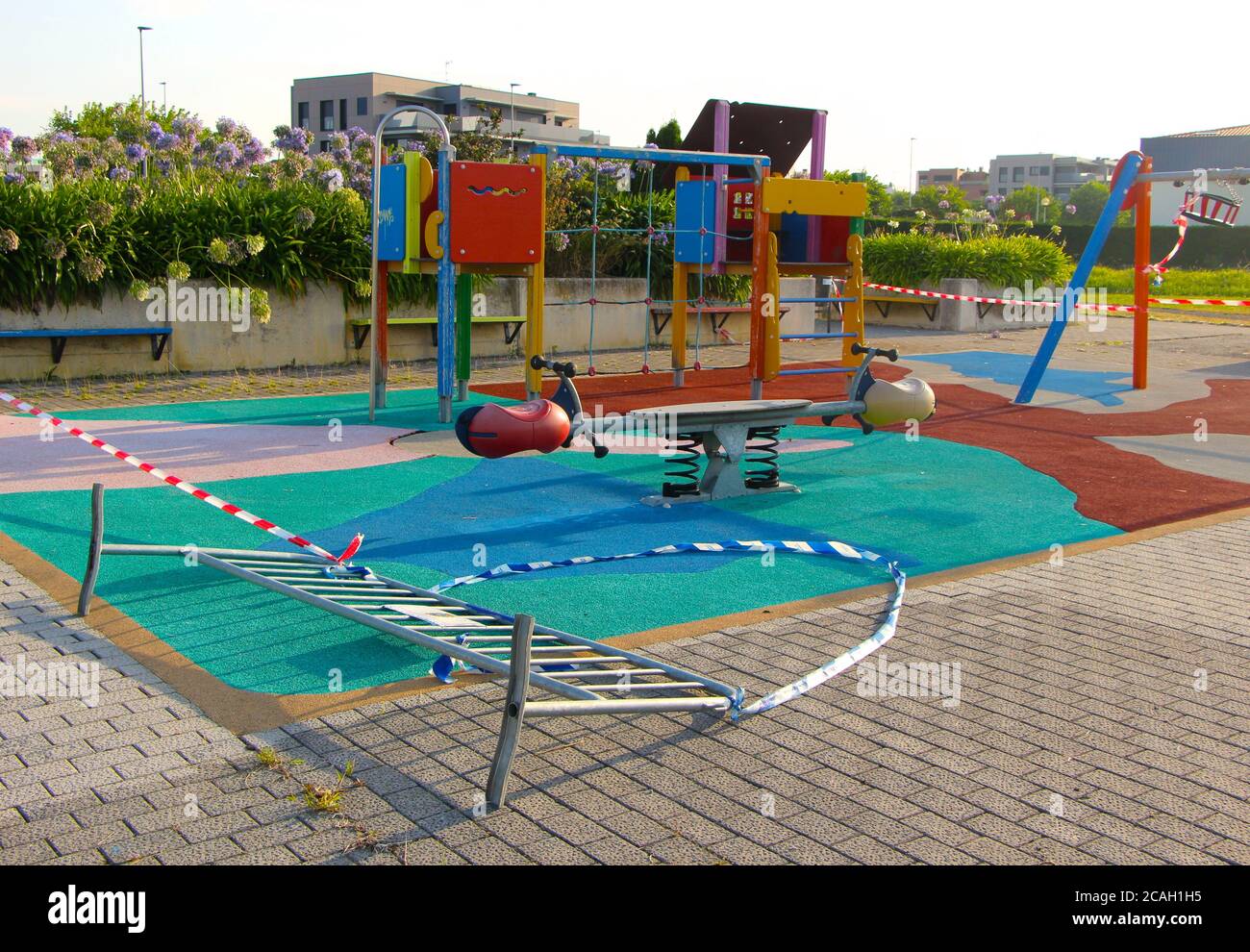 Closed public childrens playground with cordons and barriers in early morning sun Santander Cantabria Spain Stock Photo
