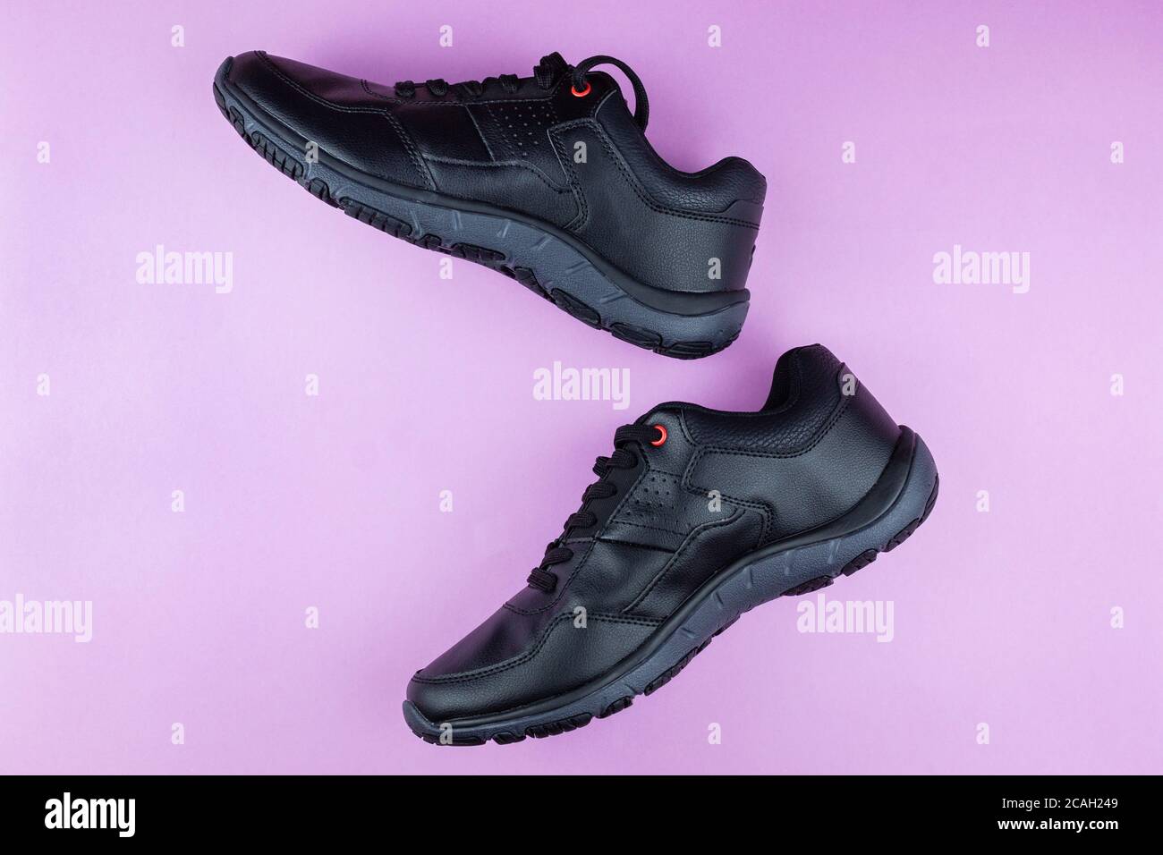 black running shoes on a pink background Stock Photo Alamy