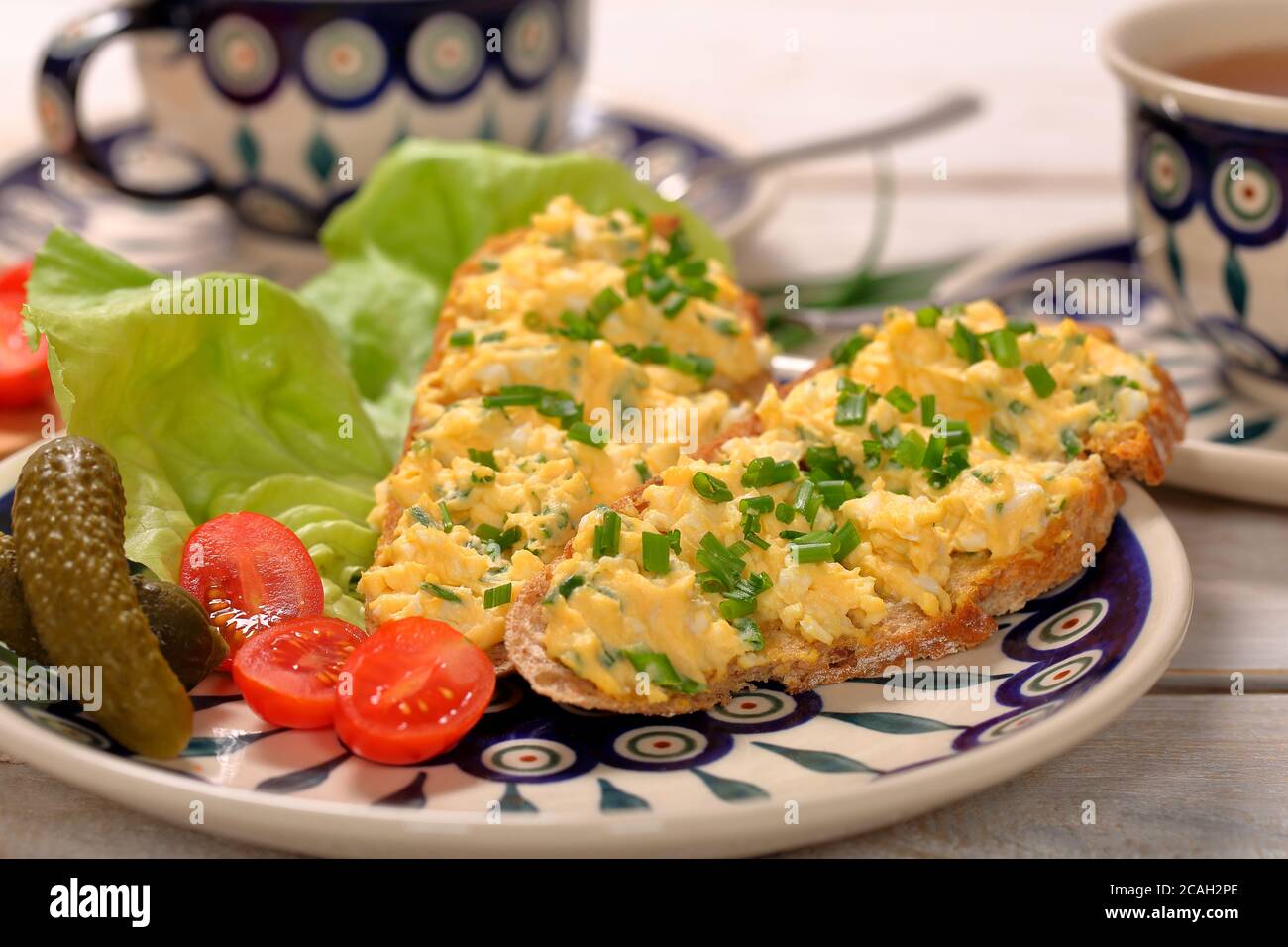 Sandwich with scrambled eggs on the plate Stock Photo