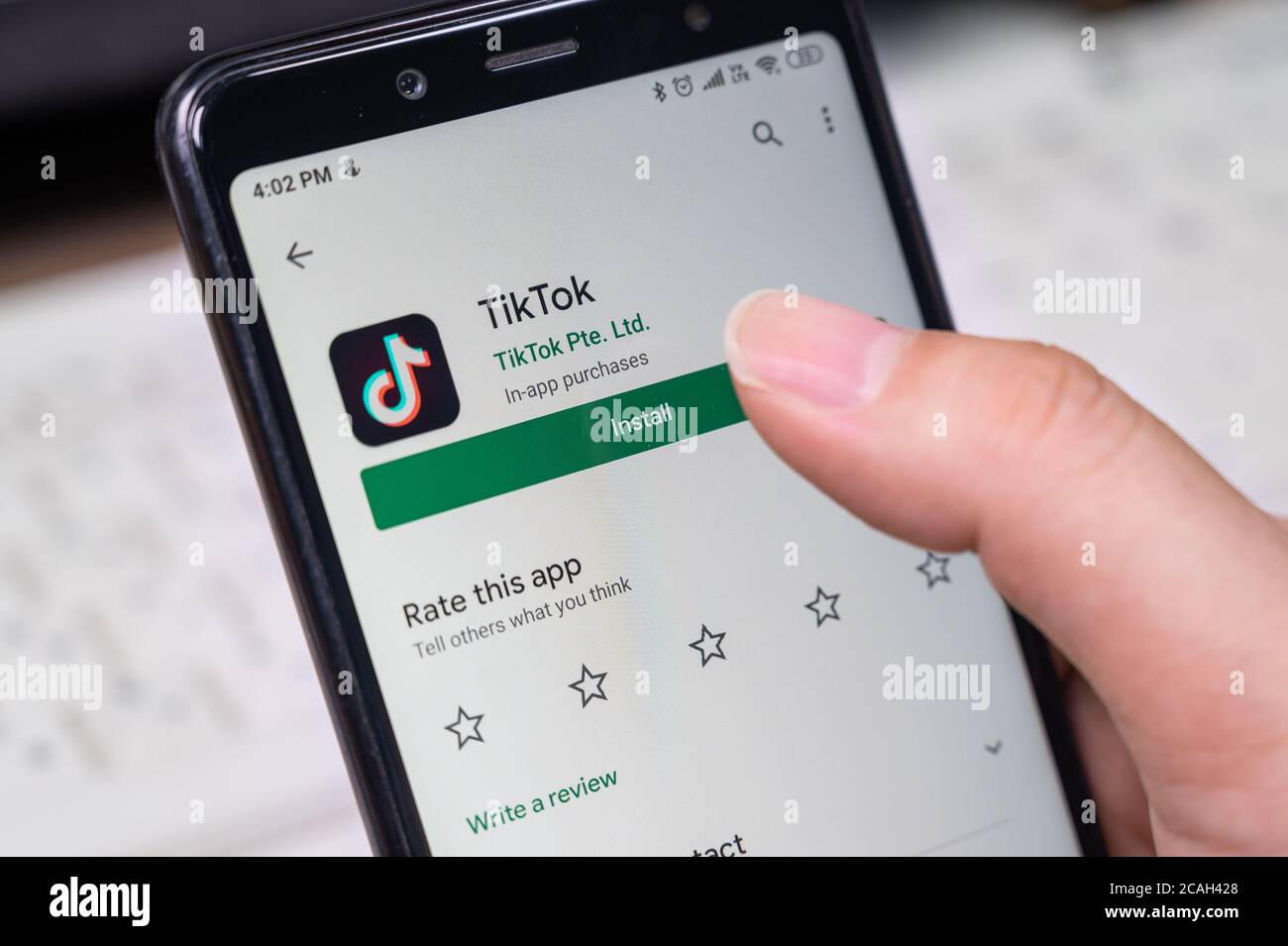 Seoul, South Korea - July 2020 : Finger close-up to install TikTok app on a smartphone. Stock Photo