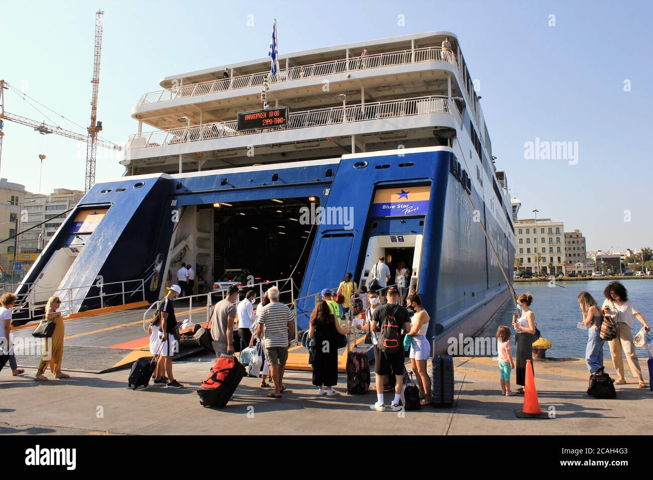 Greece, Piraeus, August 1 2020 - Passengers embarking on a ferry boat with Greek islands as destination. Stock Photo