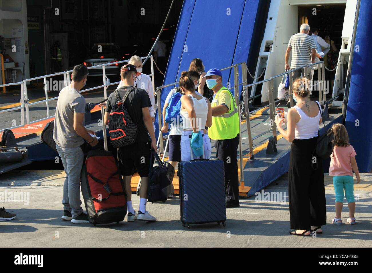 Greece, Piraeus, August 1 2020 - Passengers embarking on a ferry boat with Greek islands as destination. Stock Photo