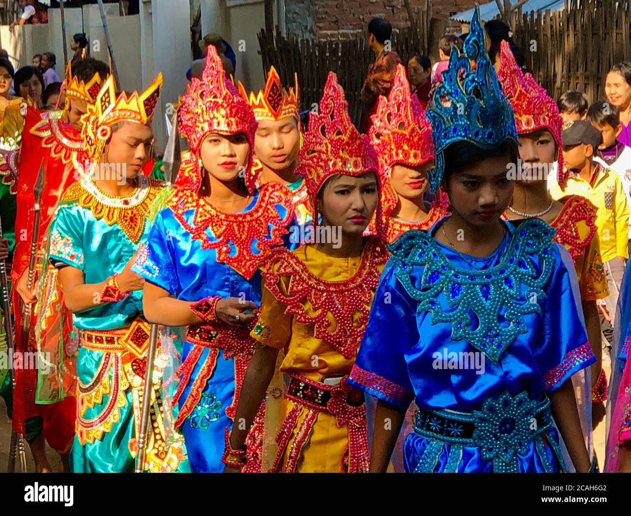 Procession of monk induction ceremony with colorful traditional attires in Bagan, Myanmar Stock Photo