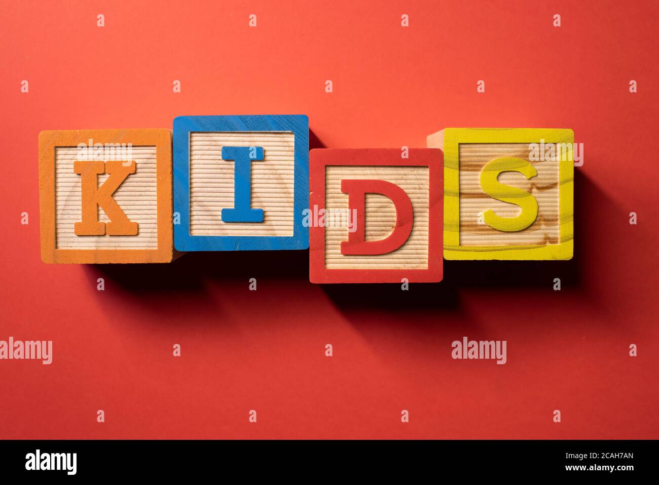 Word Kids written with wooden colored cubes Stock Photo