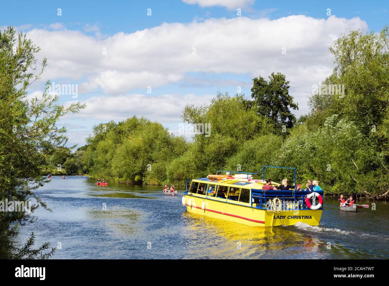 Yellow boat Lady Christina with passengers on the River Wye trip in summer at Symonds Yat West, Forest of Dean, Herefordshire, England, UK, Britain Stock Photo