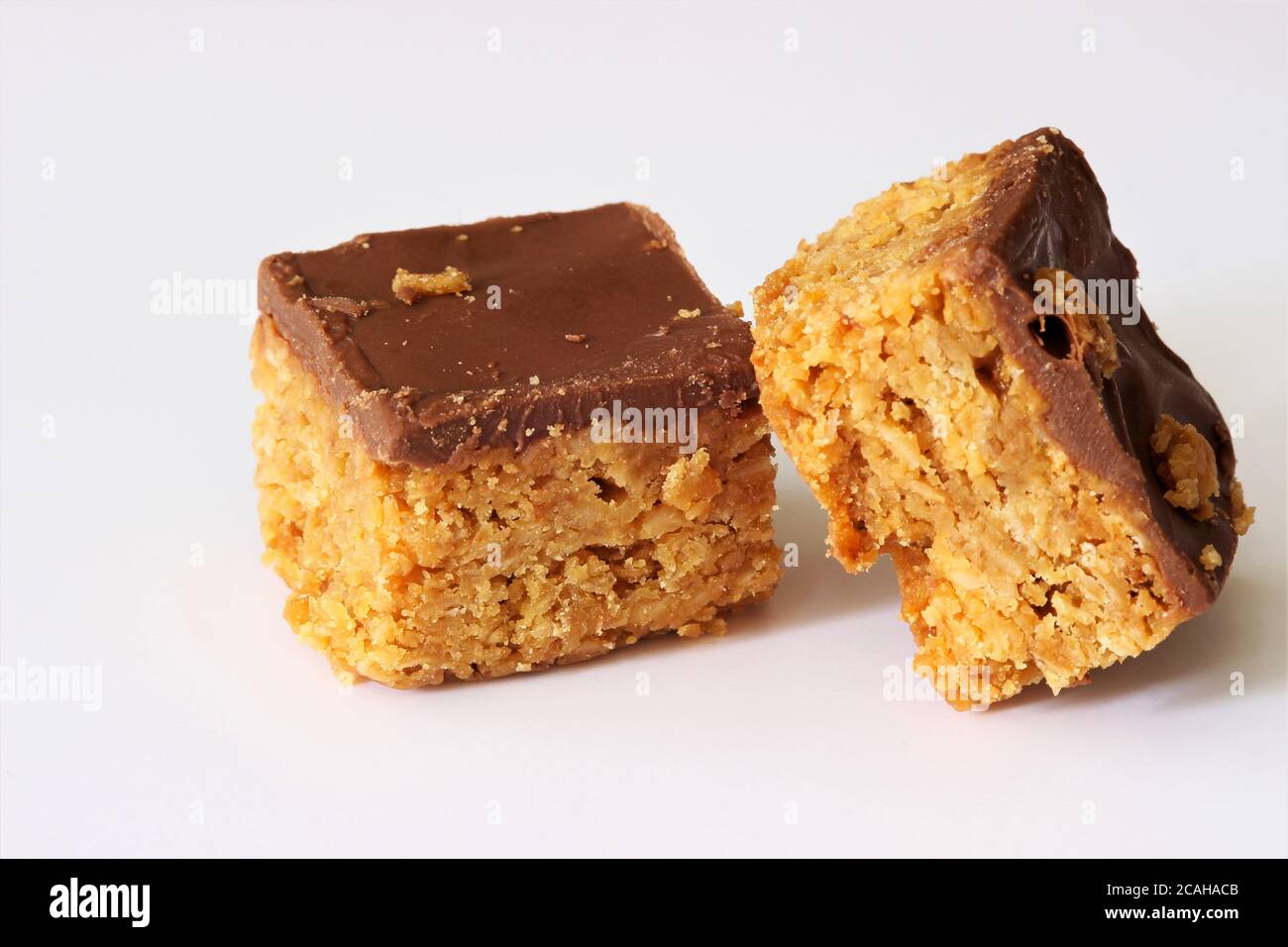 Two pieces of chocolate covered flapjack Stock Photo - Alamy