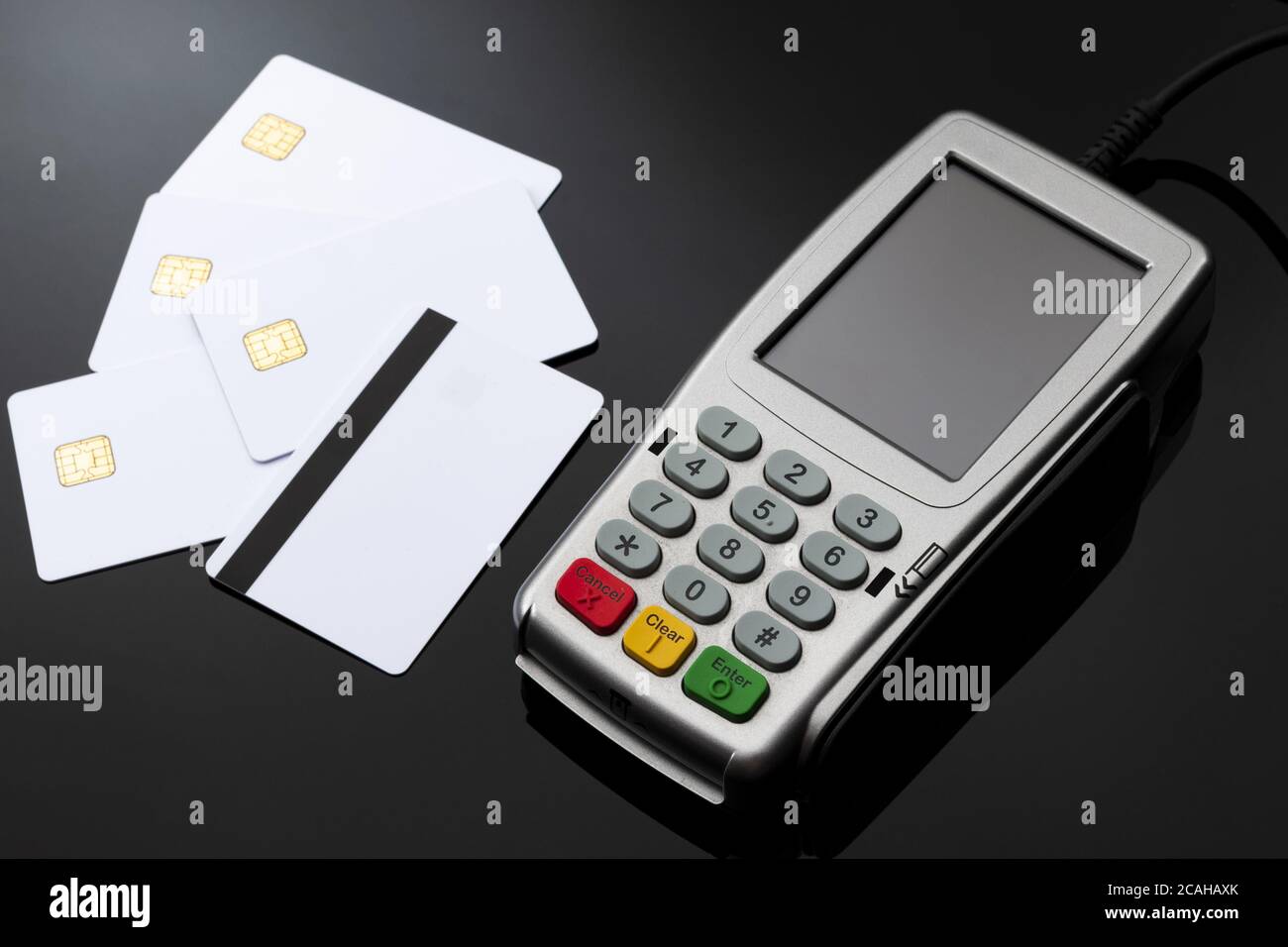 Checkout cashier, financial transaction and electronic payments concept with credit and debit card reader with rubber keyboard next to blank white mag Stock Photo