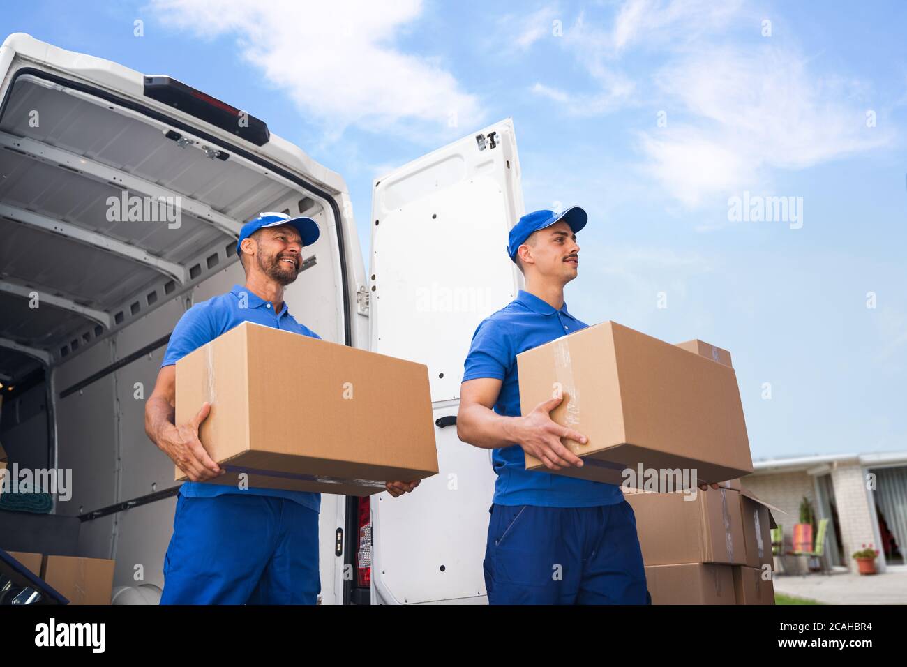 Truck Movers Loading Van Carrying Boxes And Moving House Stock Photo Alamy