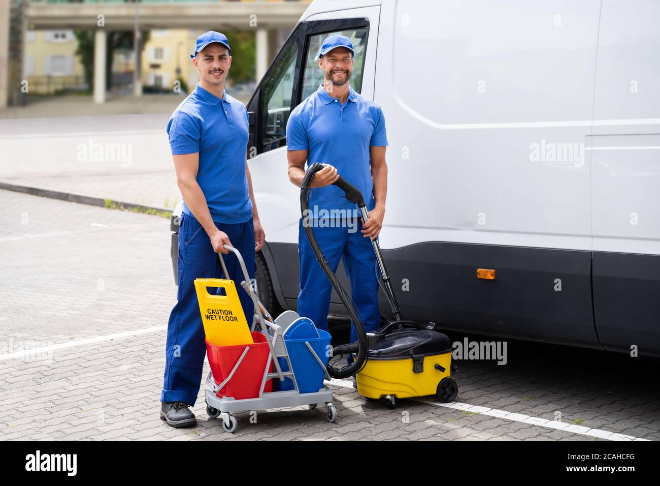 Guy With Vacuum Cleaner And Worker Near Truck Stock Photo Alamy