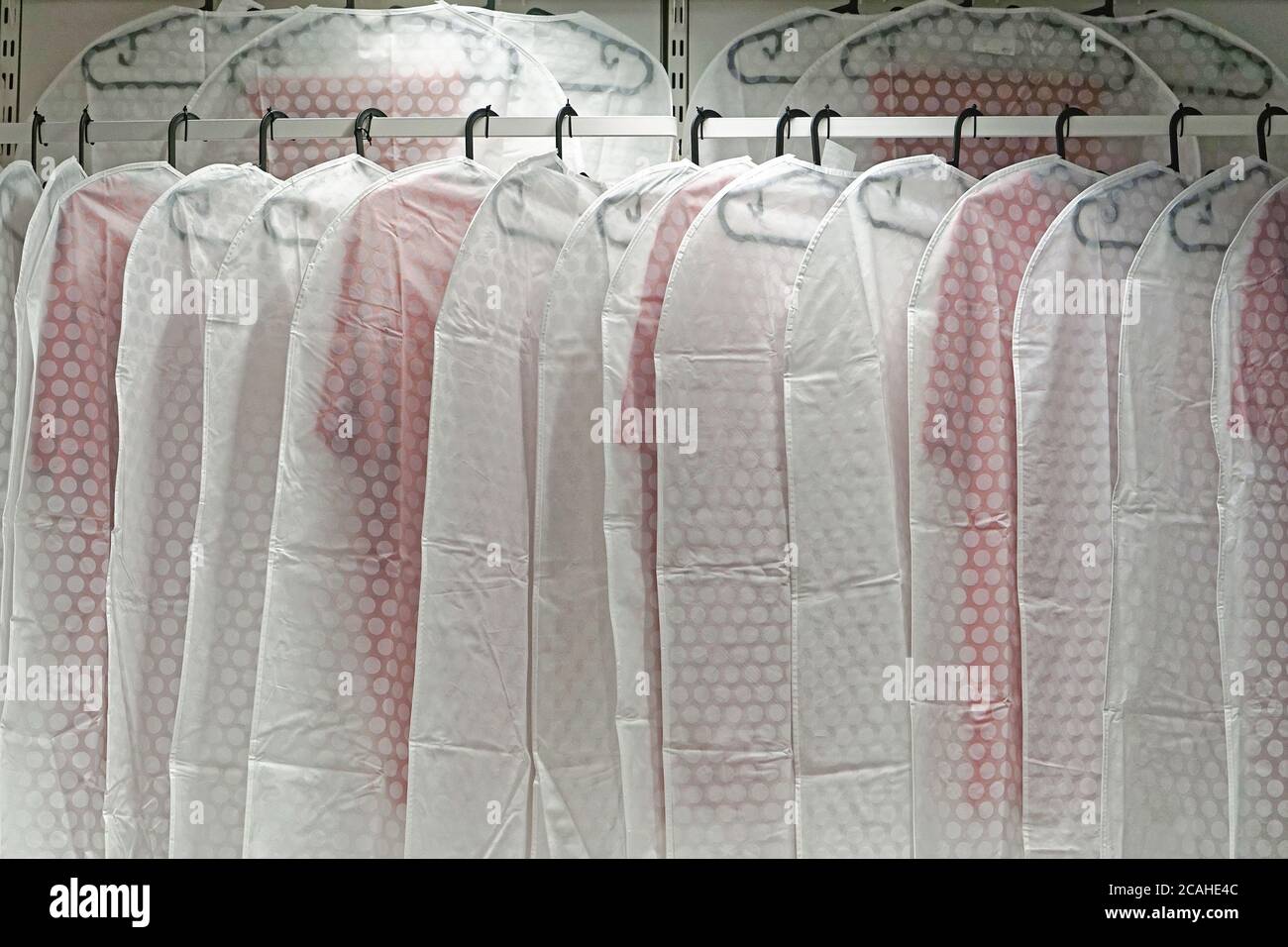 Hanging garment clothing covers dust protection in closet Stock Photo