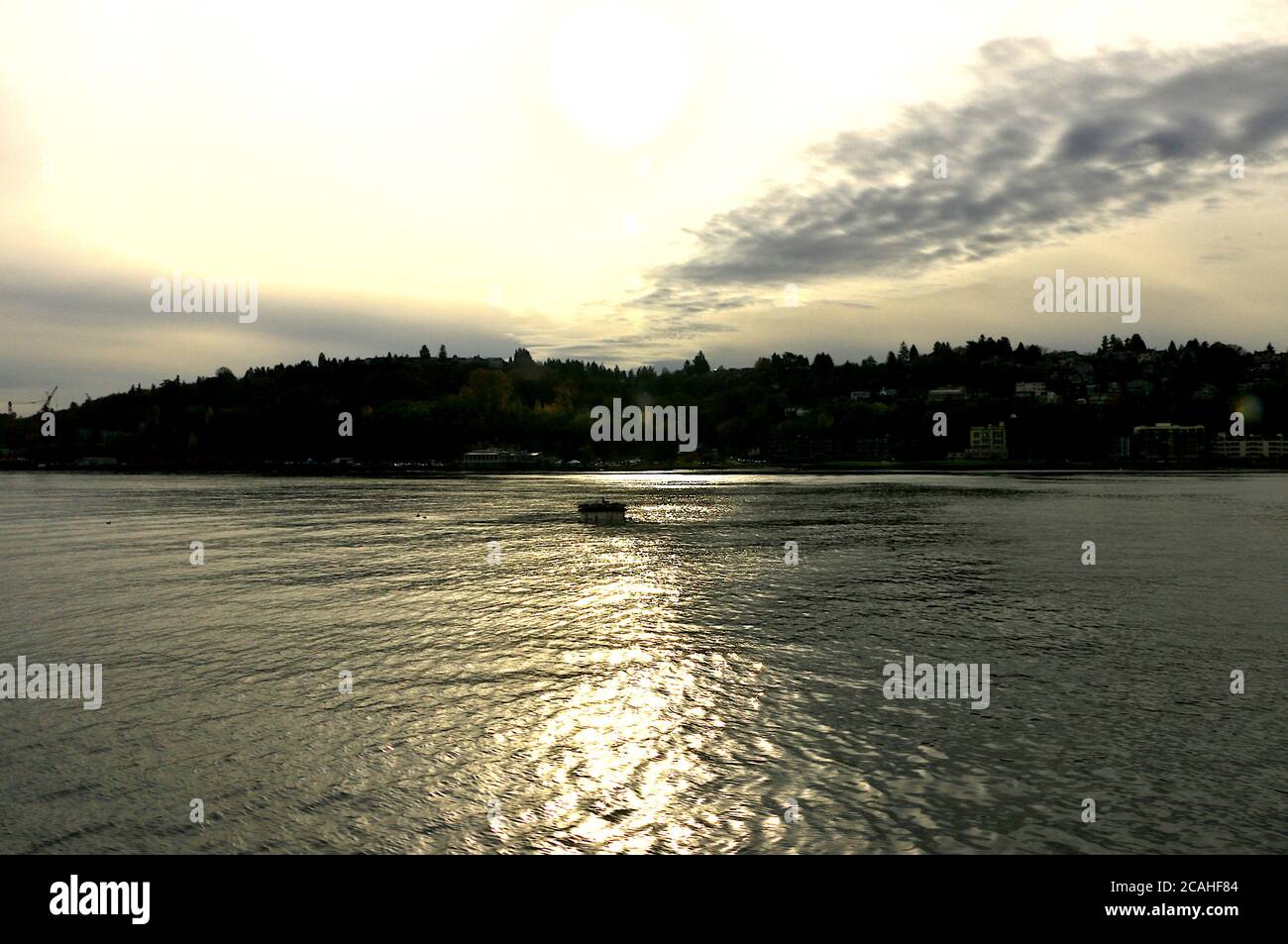 Beautiful calm lake surrounded by greenery under a cloudy sky Stock ...